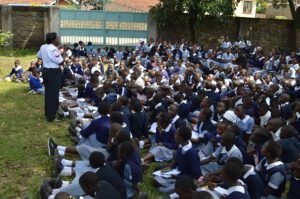 Coporal Beth Kamau from Kaptembwo Police Station gender desk during sensitisation forum on violence prevention at Koinange Primary School.