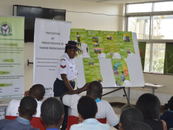 Gender officer from Kaptembwo police station leading discussions on 101 Q&A booklet on police at KNLS Nakuru Library